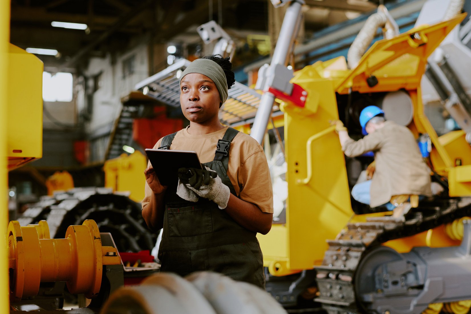 African American Woman Working at Machinery Production